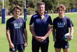 Shaun Tatlow, Steve McFarland, Flynn Peacock - young rugby players and coach stand in a field.