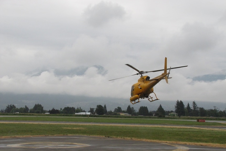 An emergency services helicopter lands at an airfield in Canada in the search for Sophie Dowsley.