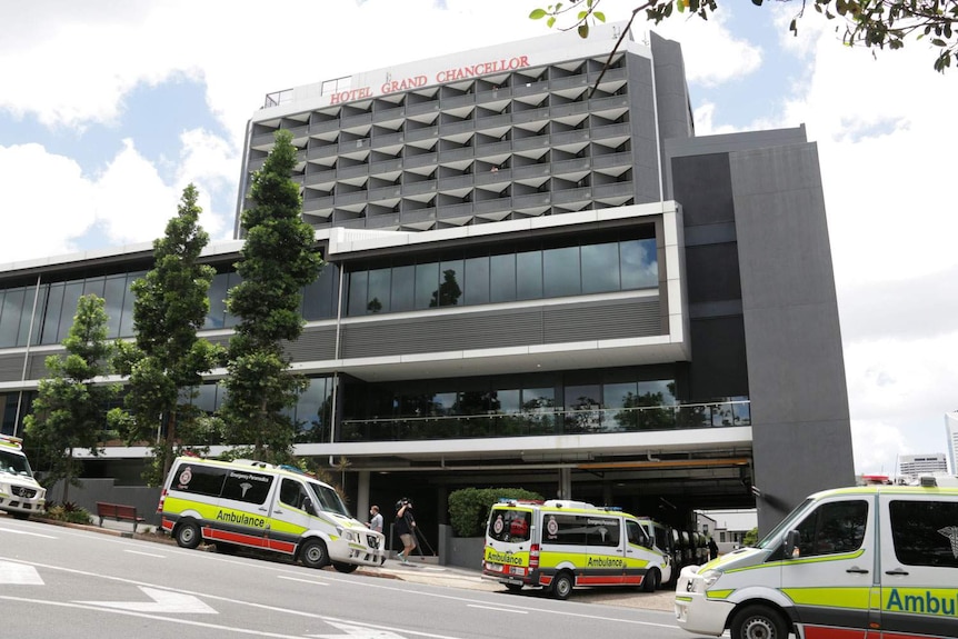 Ambulances lined up in the street and under the Hotel Grand Chancellor building at Spring Hill in Brisbane