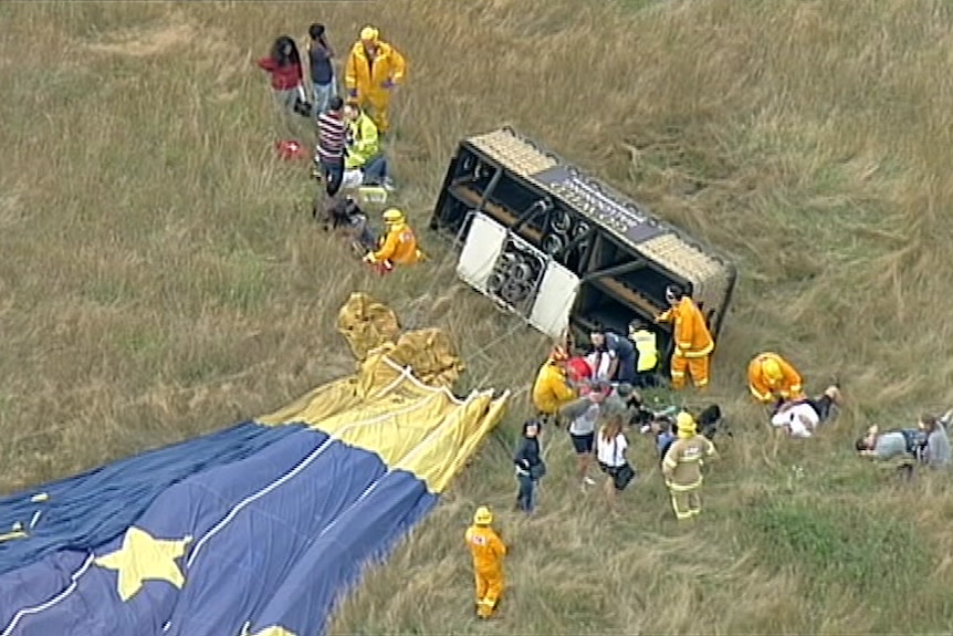 People are assessed by paramedics after a hot air balloon made a hard landing at Dixon's Creek.