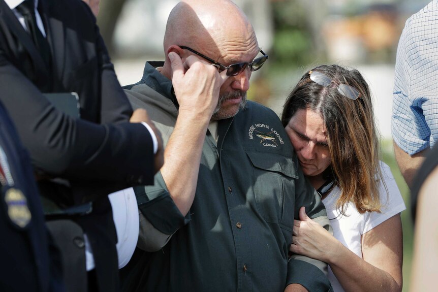 Pastor Frank Pomeroy and his wife Sherri cry outside the scene at a news conference