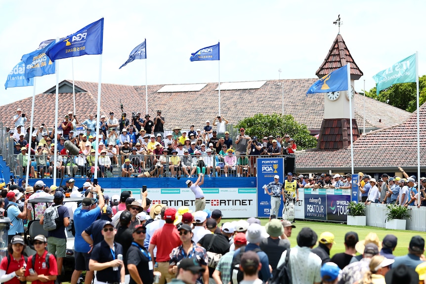 A large crowd watches on as Cameron Smith hits a drive