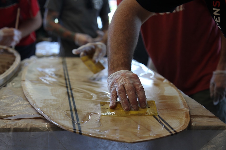 Frames getting sandwiched between fibre glassed panels of wood.