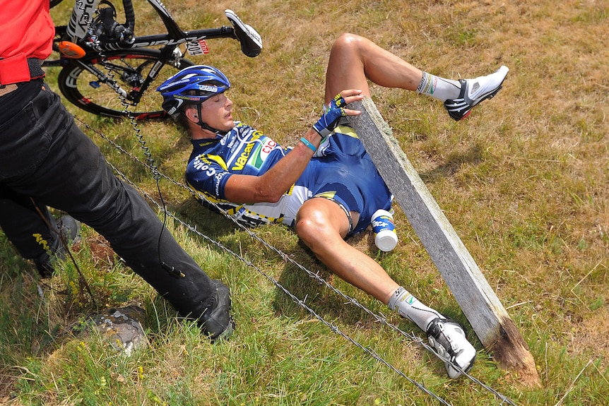 Johnny Hoogerland lies in a ditch next to barbed wire