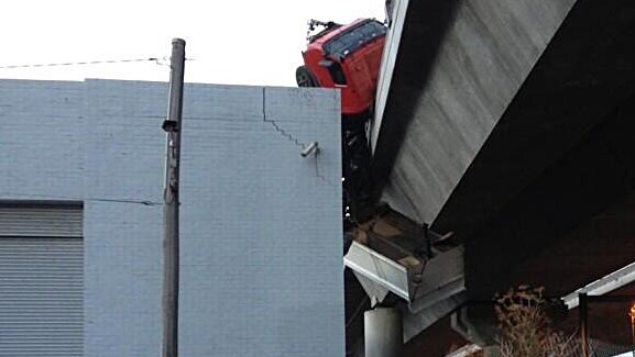 A truck hangs over the side of the Bolte Bridge.