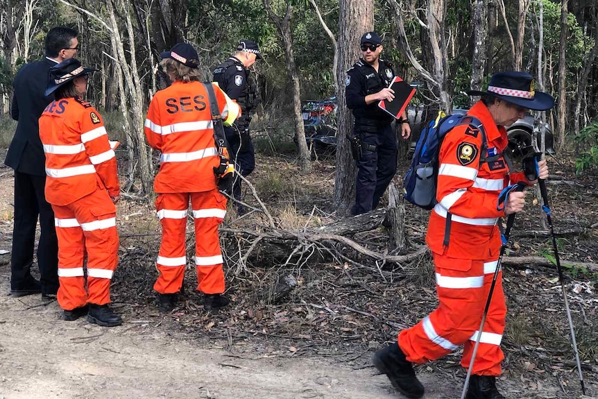 Police and SES volunteers searching bushland