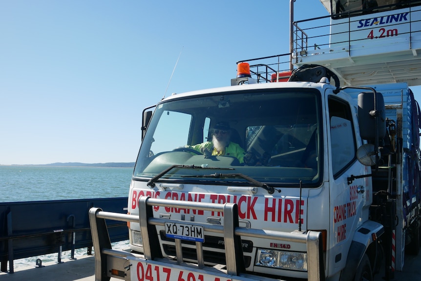 A crane truck on the vehicle barge.