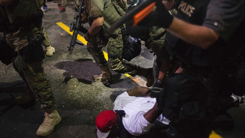 Police charged into crowds in Ferguson on Tuesday night arresting 47 people after relative calm dissolved.