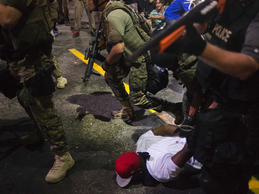 Police charged into crowds in Ferguson on Tuesday night arresting 47 people after relative calm dissolved.