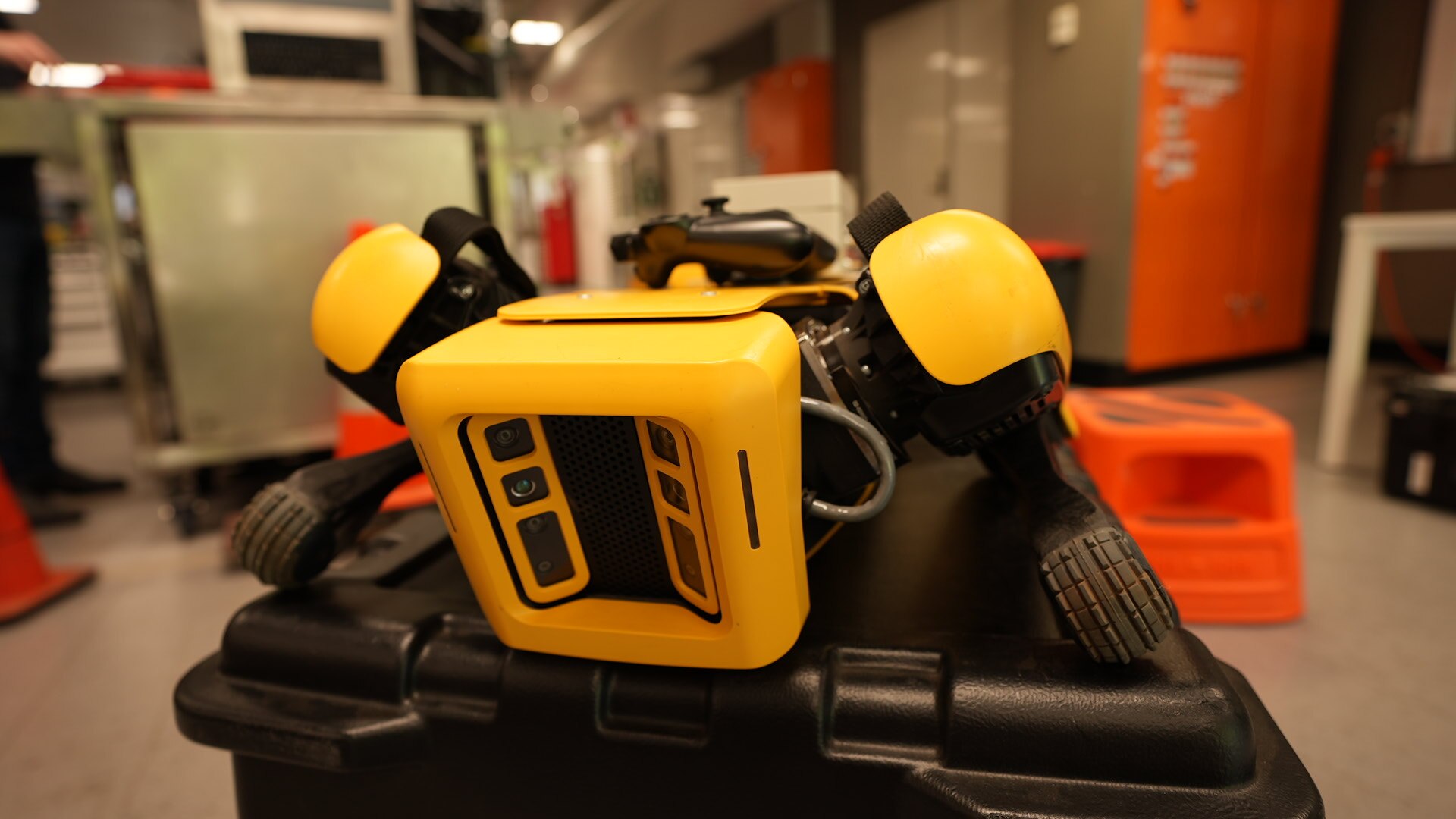 a robot dog lying down on a box