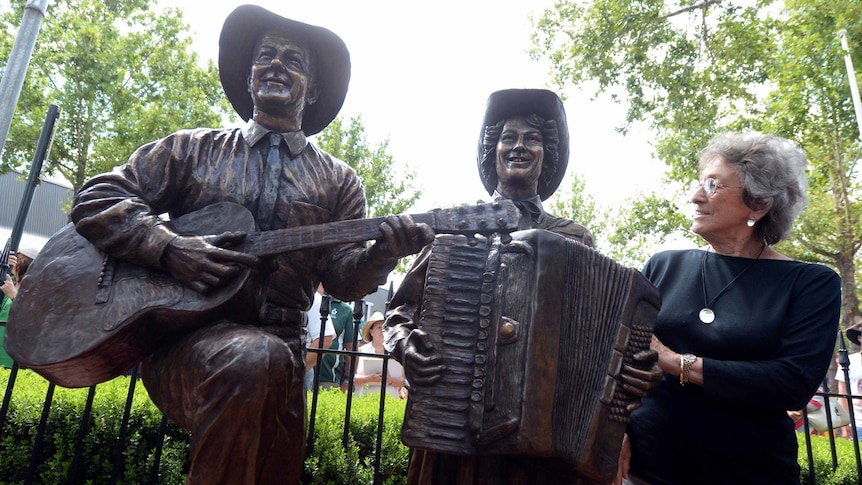 Country music legend Joy McKean stands next to a bronze statue of Slim Dusty and herself that was unveiled at the 42nd Tamworth Country Music Festival on January 24, 2014.