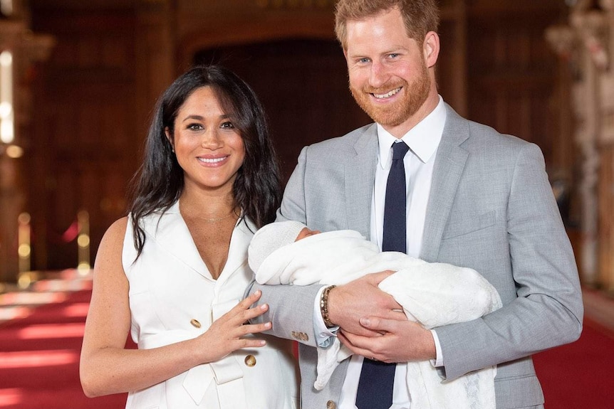 Prince Harry and Meghan Markle hold baby Sussex.