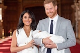 Prince Harry and Meghan Markle hold baby Sussex.