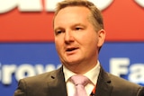 Immigration Minister Christopher Bowen addresses delegates during the National ALP Conference