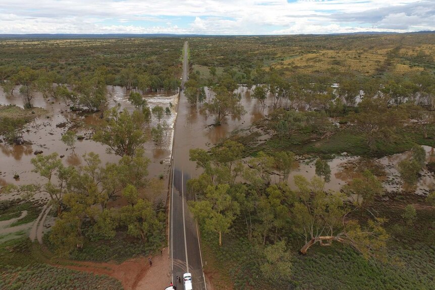 A flooded roadway in remote Northern Territory, cutting off communities from supplies.