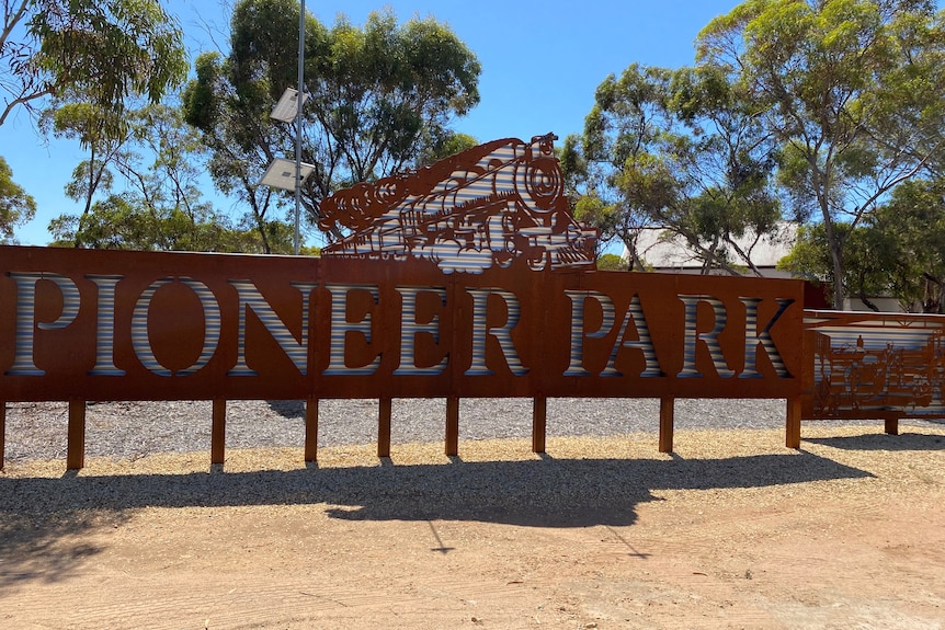 A big metal sign of a train and the words Pioneer Park