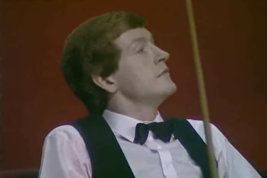 Steve Davis sits and looks to his left with a bemused look on his face
