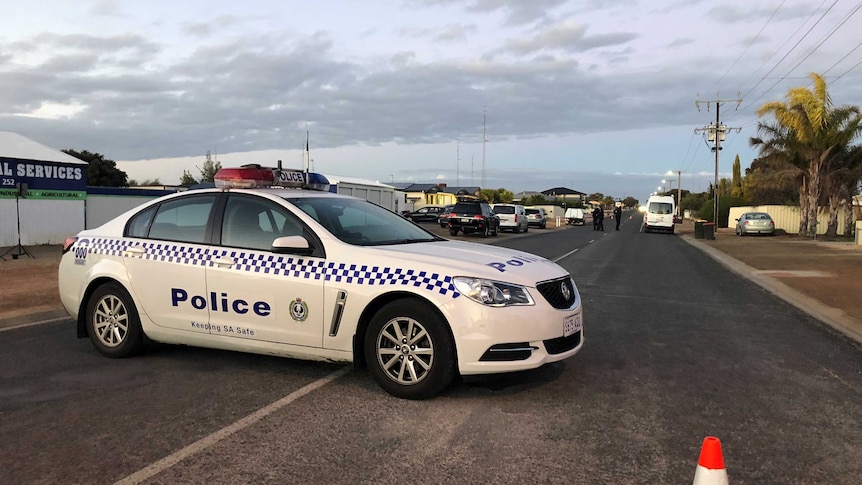 A police car on a country town road.