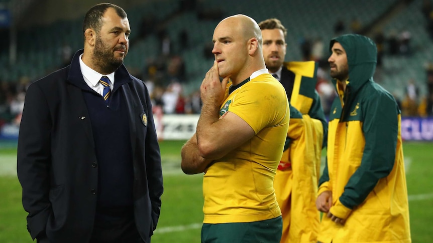 Wallabies coach Michael Cheika talks to skipper Stephen Moore after Australia's loss to England.