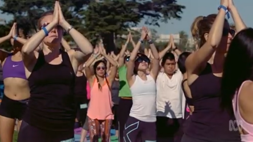 Screenshot of a group of people meditating from ABC's Catalyst program