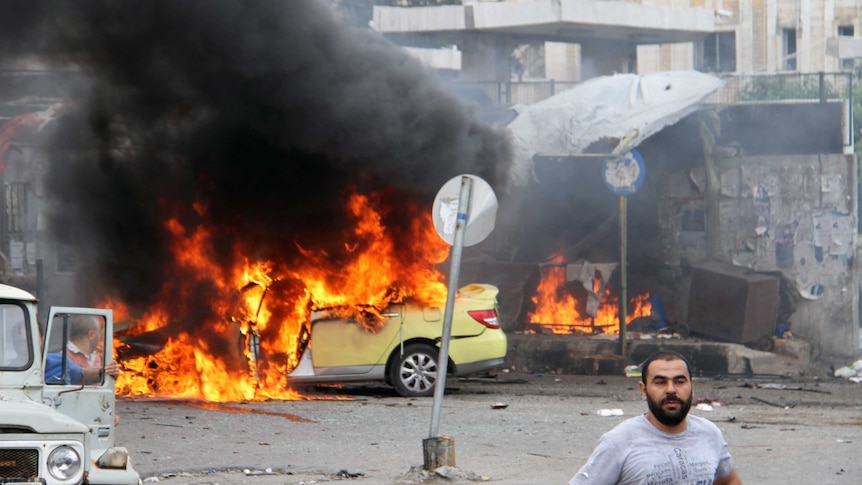 A car on fire after a bomb blast in Tartus.