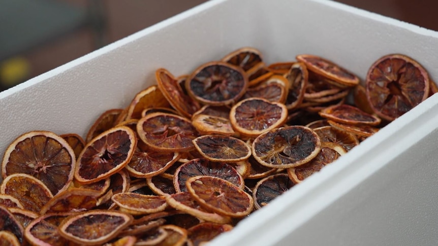 Dried slices of pink oranges in a tub.