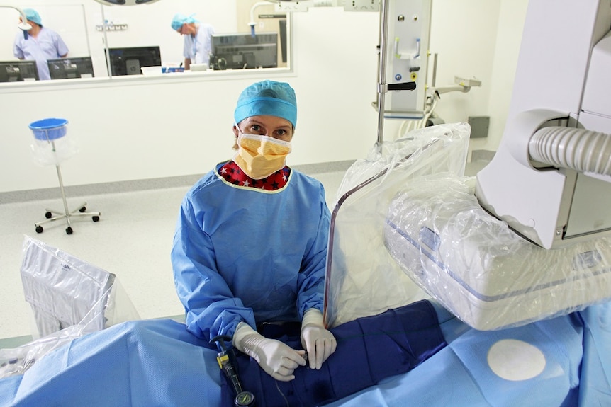 A doctor stands in operating theatre.