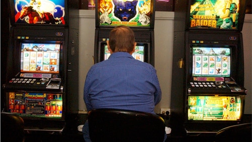 a man sitting at a poker machine