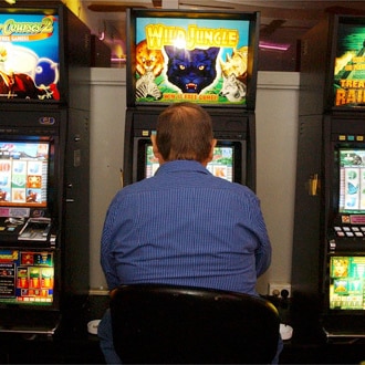 A punter playing the poker machines in a Sydney club 