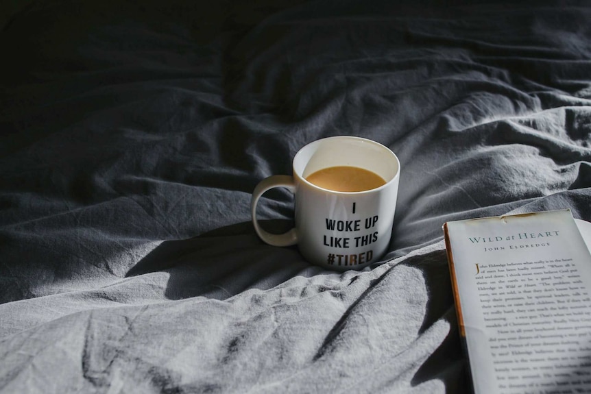 A coffee mug that says #tired to be consumed by someone struggling to sleep during coronavirus