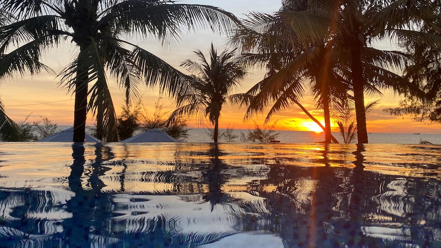 A sunset over a pool at a resort in Vietnam
