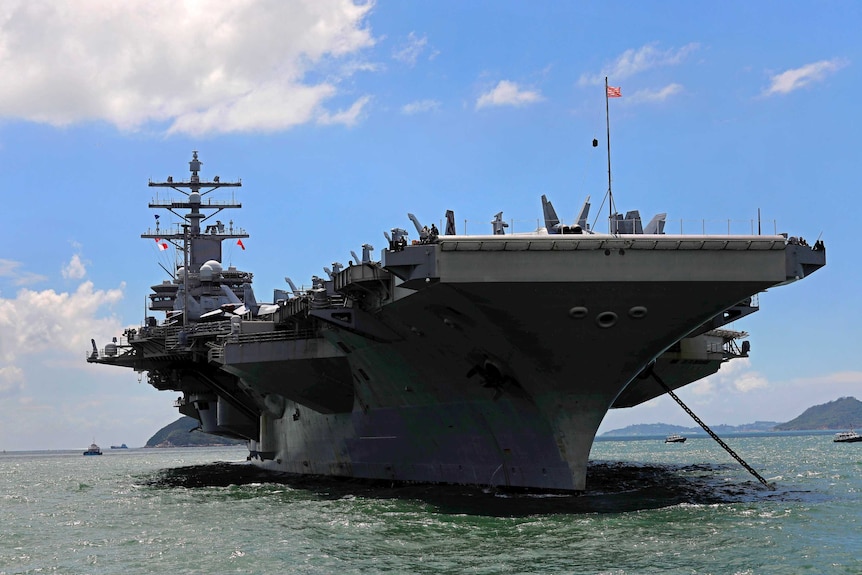 A front on shot of the USS Ronald Reagan aircraft carrier.