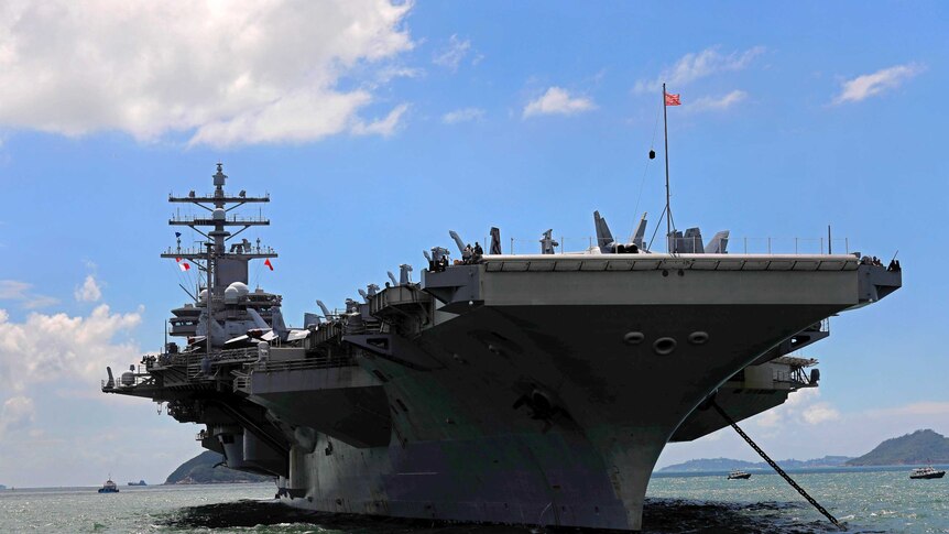 A front on shot of the USS Ronald Reagan aircraft carrier.