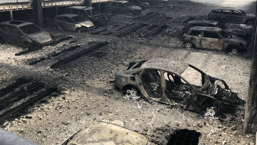 Burnt out cars inside a severely fire damaged car park