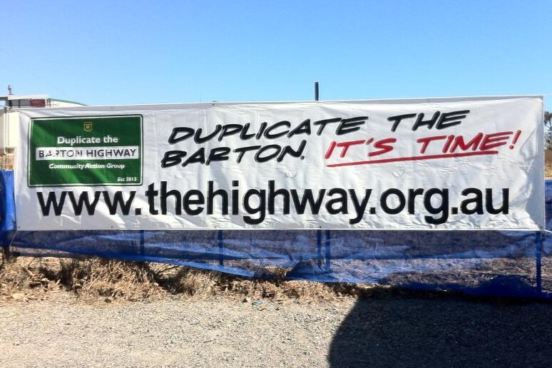 A large sign saying "duplicate the Barton, it's time".