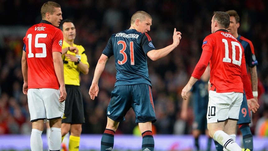 Bayern Munich's Bastian Schweinstiger argues with Manchester United's Wayne Rooney after red card.