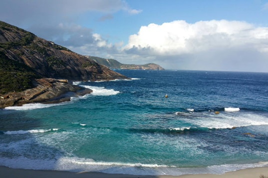 Beach with rocky outcrop.