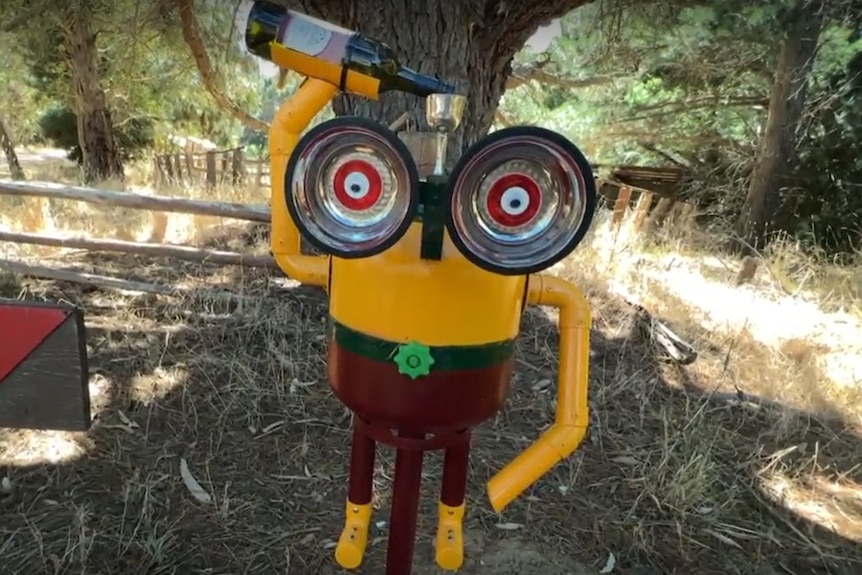 A minion pouring wine into a glass on its head