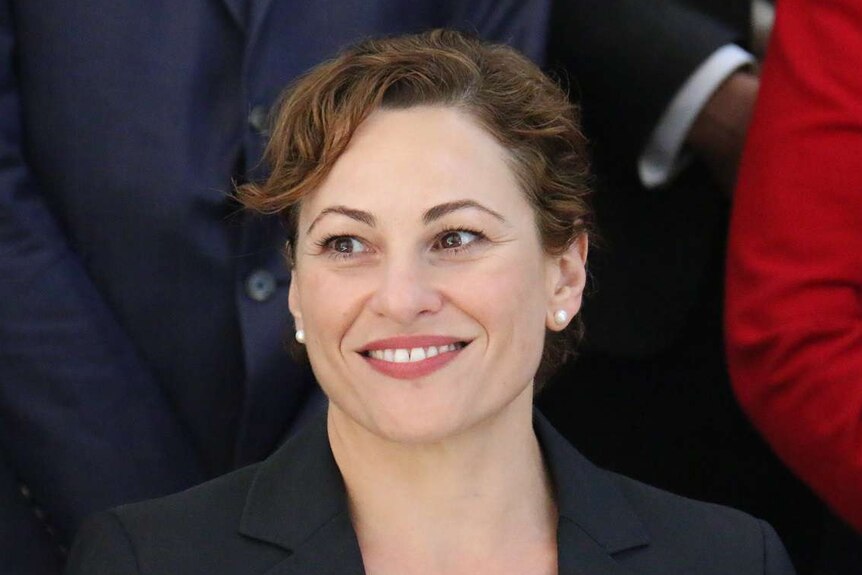 Jackie Trad looks off camera, smiles