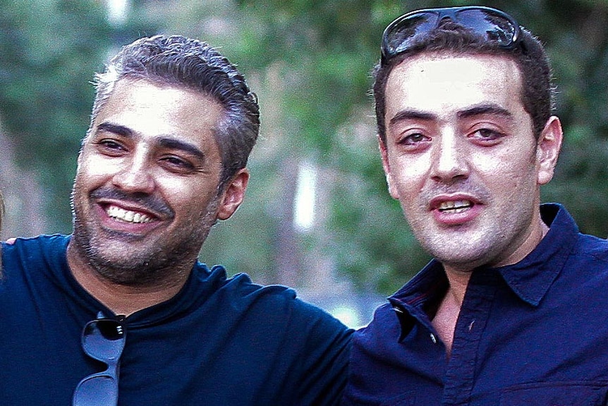 Al-Jazeera journalists Mohamed Fahmy and Baher Mohamed celebrate after being released from prison.