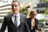 Former Cronulla Sharks rugby league player Greg Bird arrives at court with girlfriend Katie Milligan
