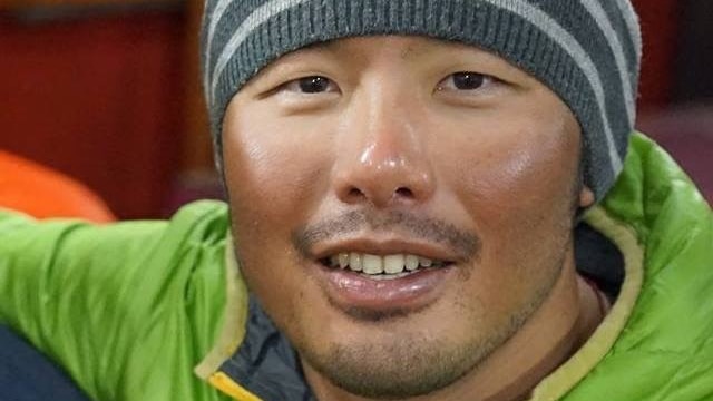 Canberra man Gilian Lee wears a grey striped beanie and a green jacket.