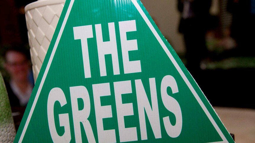 A close-up photo of a Greens cardboard sign.