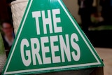 A close-up photo of a Greens cardboard sign.