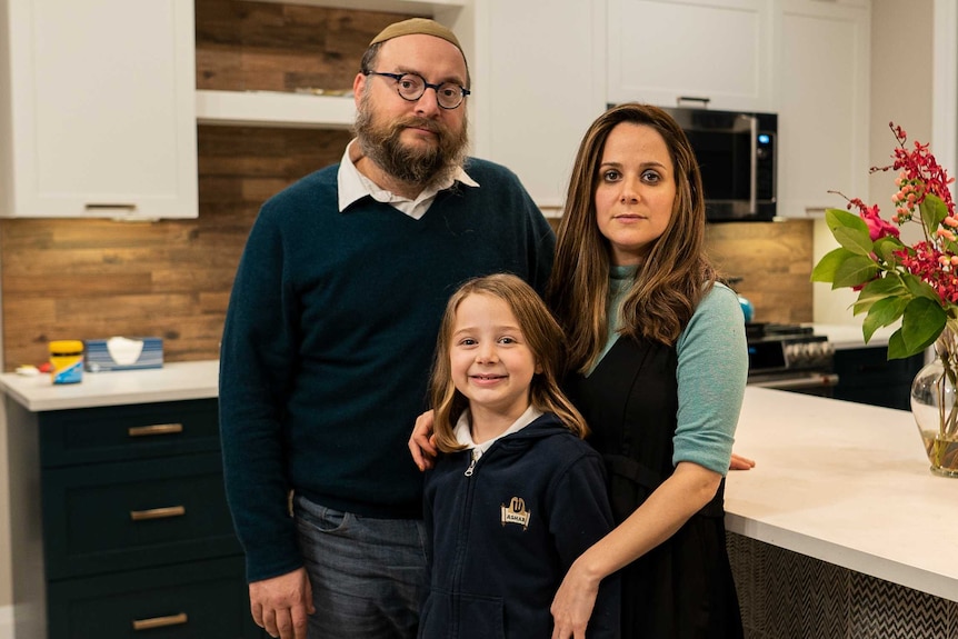 A man, a woman and a child in a kitchen