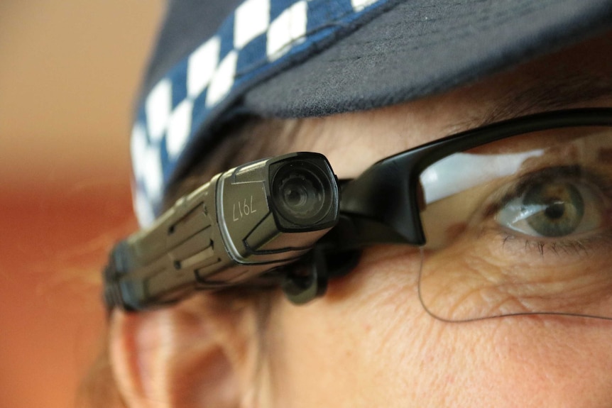 Police woman wearing sunglasses mounted with a small camera
