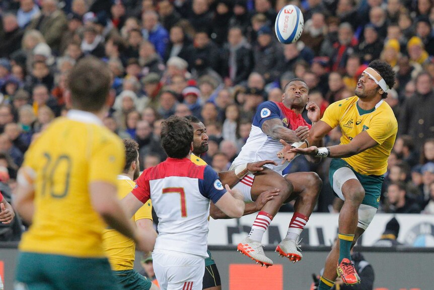 Aerial battle ... Wallabies winger Henry Speight challenges Virimi Vakatawa for a high ball