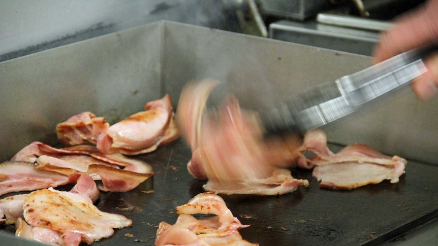 Bacon being cooked on a hotplate