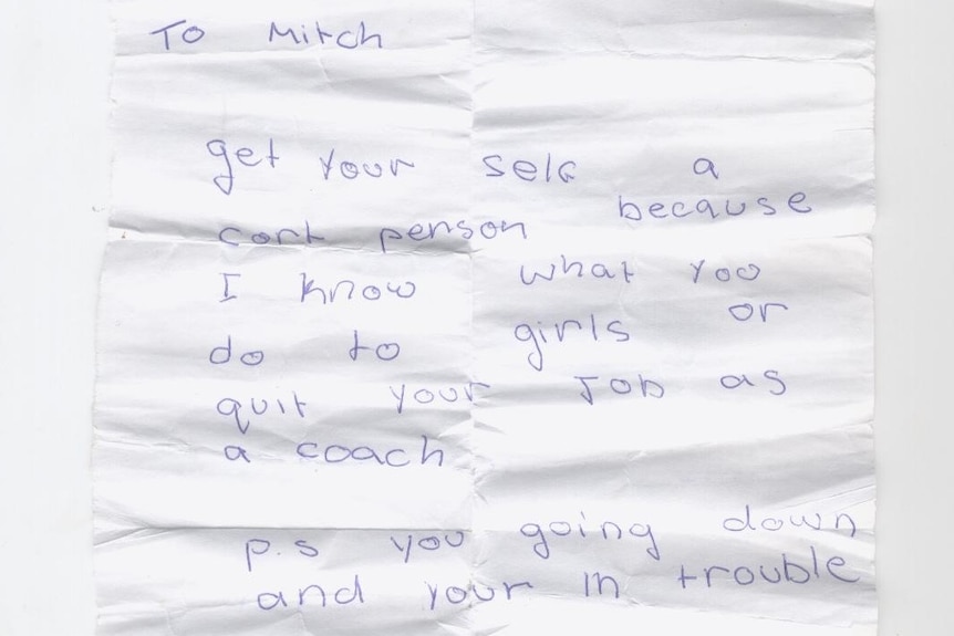 Writing on a white piece of paper says 'To Mitch, get yourself a court person because I know what you do to girls'.