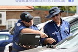 Odometer inspectors at a car yard